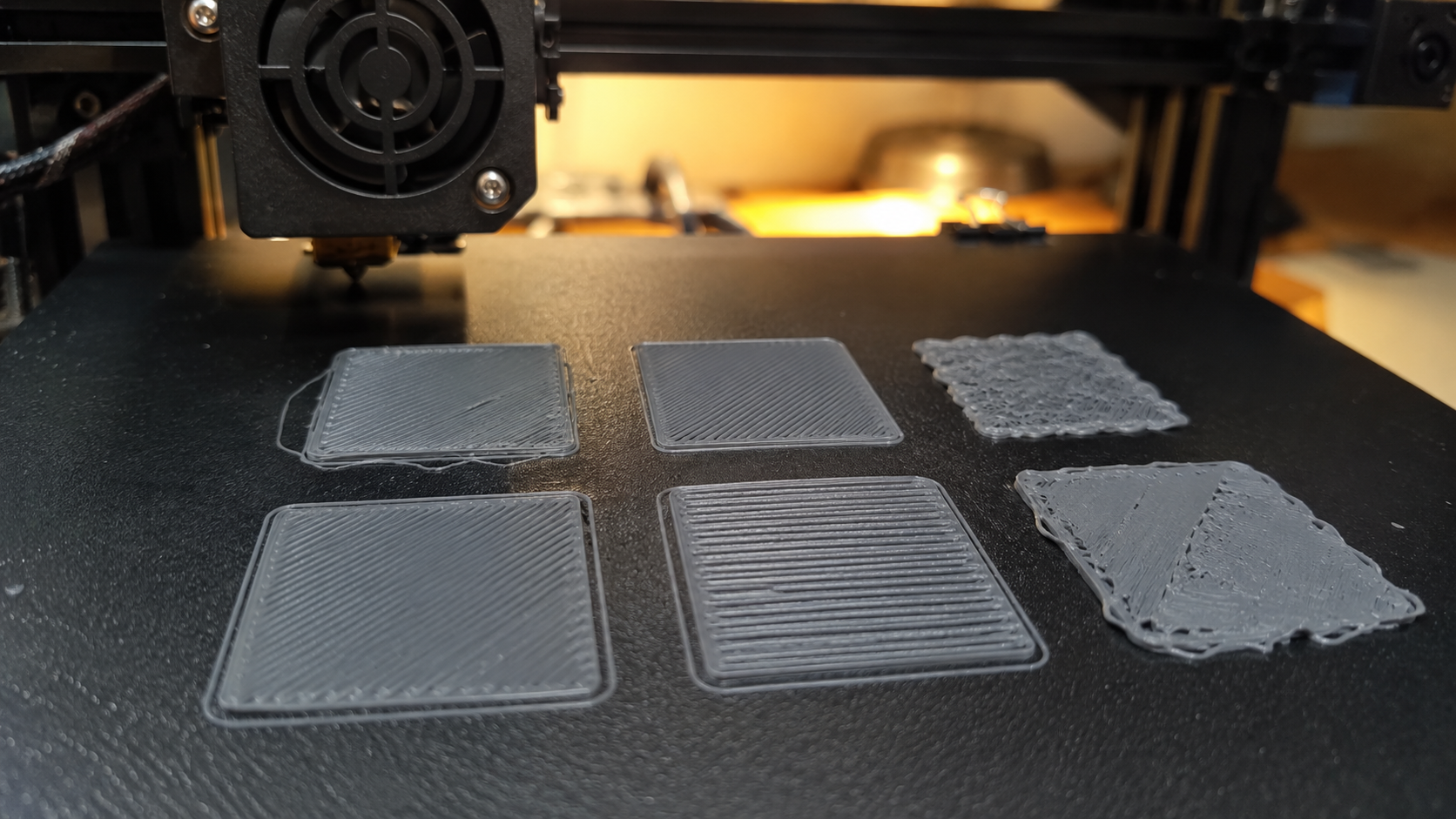 Close-up of 3D printer build plate showing first-layer extrusion patterns with correct and incorrect Z-offset comparison -- 3D printing troubleshooting bed adhesion