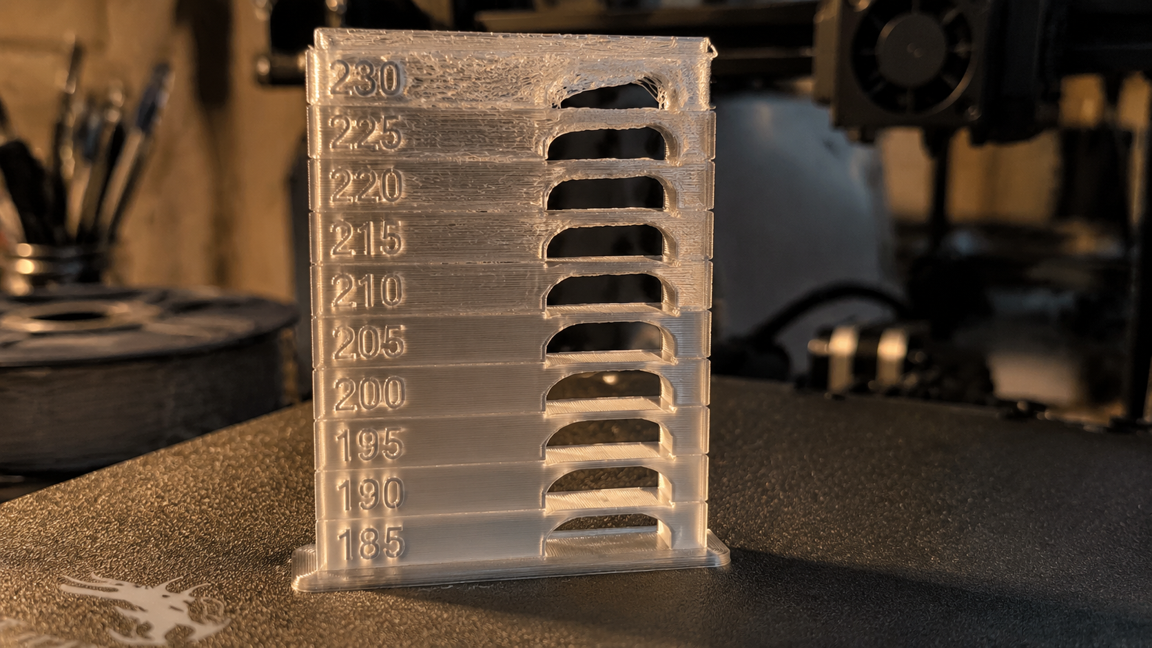 PETG temperature tower print showing extrusion quality at different nozzle temperatures from 230C to 260C on a textured build plate