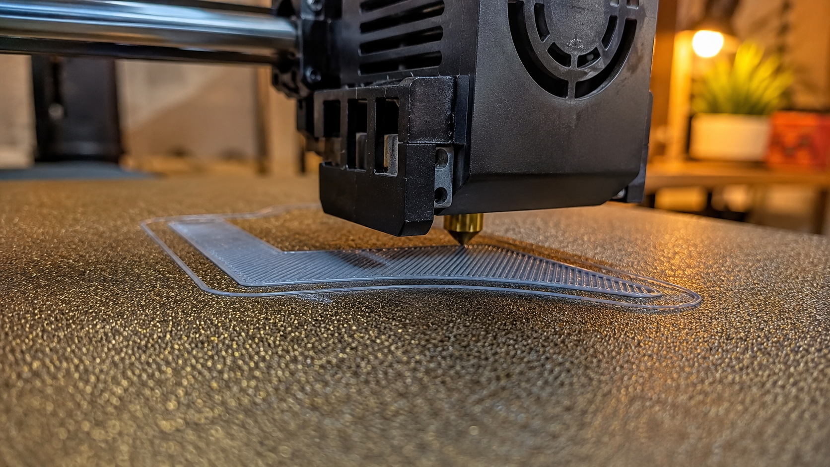First layer of PETG printing on a build plate showing proper squish and bed adhesion with correct Z-offset calibration